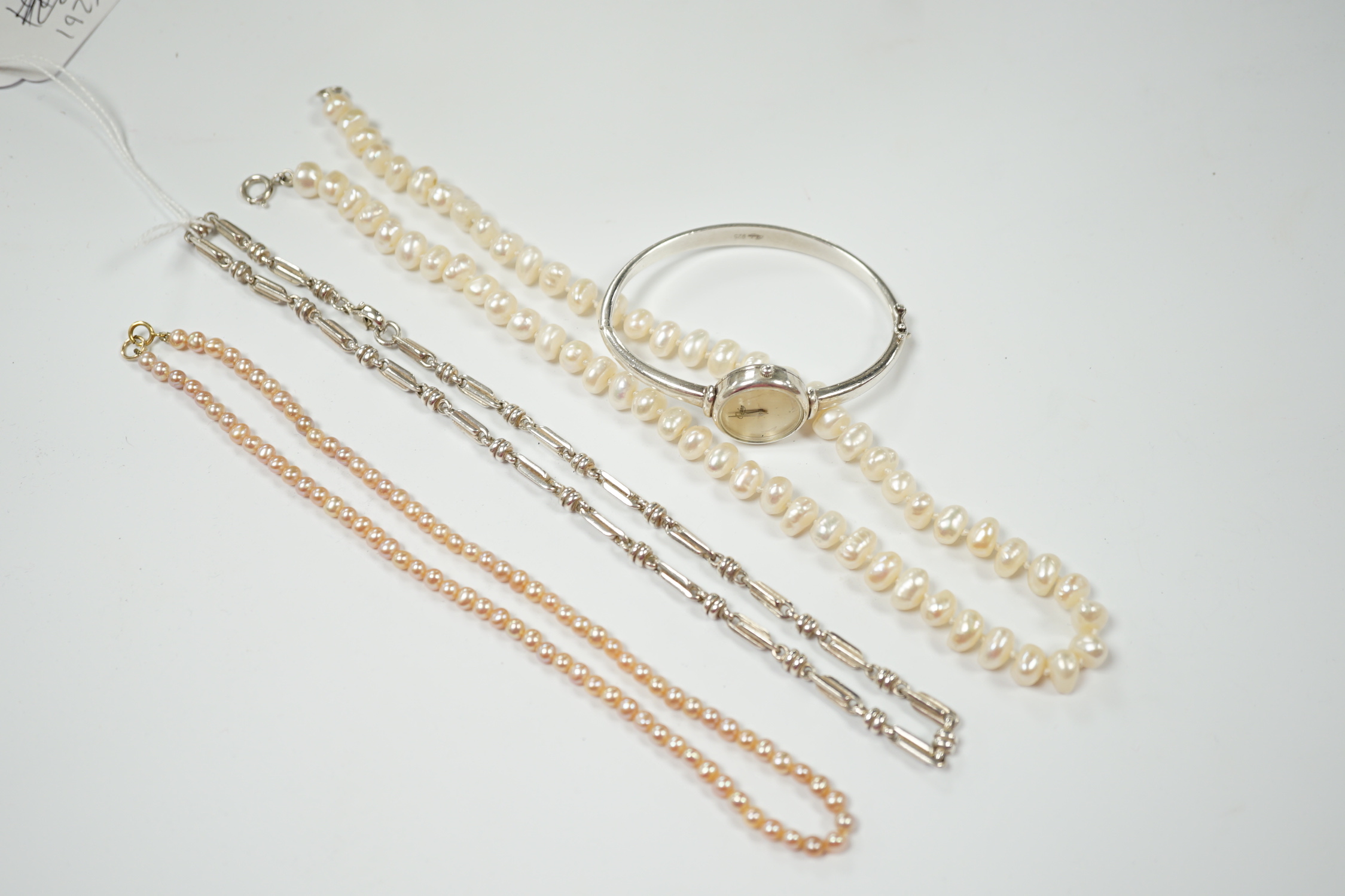 A modern 925 chain, a lady's 925 bangle watch and two cultured pearl necklaces.